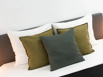 a pile of pillows sitting on a couch at Filomena Apartments ORIENTAL in Mindelo