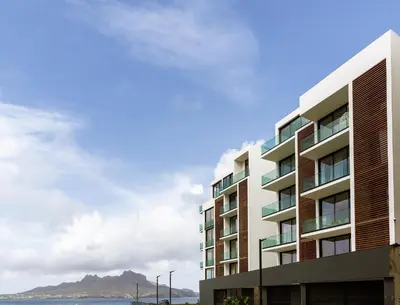 a large apartment building with a view of the ocean at Filomena Apartments ORIENTAL in Mindelo
