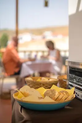 a plate of food on a table with bread at Encosta Azul in Cidade Velha