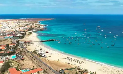 an aerial view of a beach with boats in the water at Kyaala Djadsal Moradias pool&sea in Santa Maria