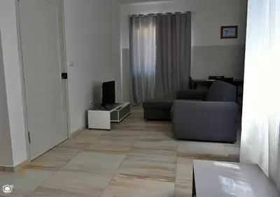 a living room with a couch and a television at TARRAFAL SN TOUR in Tarrafal
