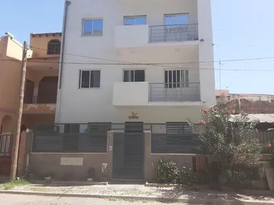 a white building with black balconies on it at T1 conforto in Praia