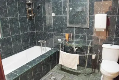 a bathroom with a tub and a toilet and a sink at T1 conforto in Praia