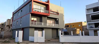 a building with a balcony on the side of it at Apartamento T1 Mobilado Espargos/Sal in Espargos
