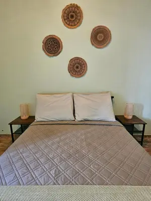 a bedroom with a bed with three plates on the wall at Casa Medina in Fajãzinha