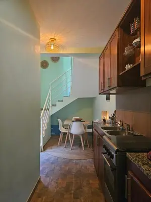 a kitchen with a table and a dining room at Casa Medina in Fajãzinha