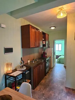 a kitchen with a sink and a table in a room at Casa Medina in Fajãzinha