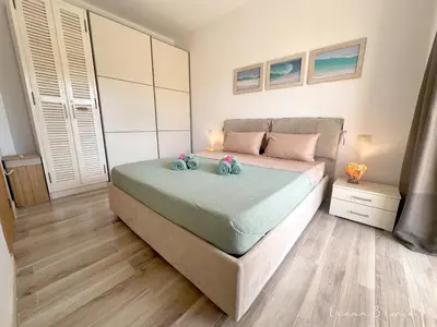 a bedroom with a large bed with pink pillows at Ocean Breeze 9 in Sal Rei