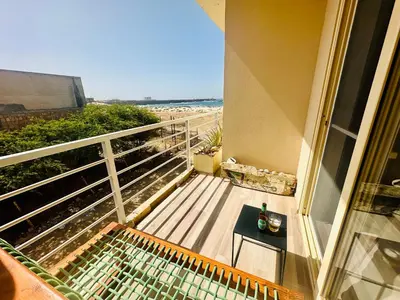 a balcony with a table and a view of the beach at Ocean Breeze 9 in Sal Rei