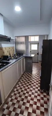 a kitchen with a checkered tile floor in a kitchen at Casas do Cinema II in Mindelo