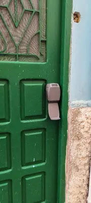 a green door with a pink mailbox on it at Casas do Cinema II in Mindelo