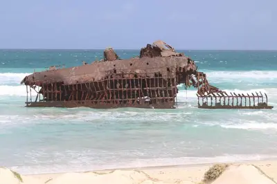 an old structure in the water on a beach at WEYt1 in Sal Rei