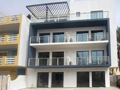 a building with a solarium on top of it at Atlantic SAL - One Bedroom Apt in Santa Maria