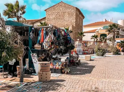 a market with clothes and other items on a street at Atlantic SAL - One Bedroom Apt in Santa Maria