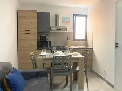 a kitchen and dining room with a table and chairs at Atlantic SAL - One Bedroom Apt in Santa Maria