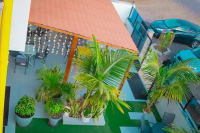 an overhead view of a house with palm trees at Hotel Xinte na casa in Tarrafal