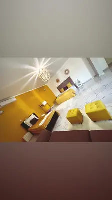 a view of a living room with yellow furniture at Hotel Xinte na casa in Tarrafal