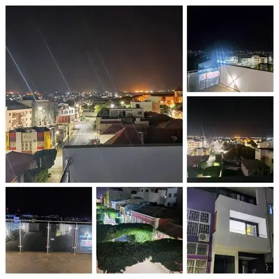 a collage of photos of a city at night at ACG Plato Terrace & Balcony Apartments in Praia