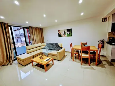 a living room with a couch and a table at ACG Plato Terrace & Balcony Apartments in Praia