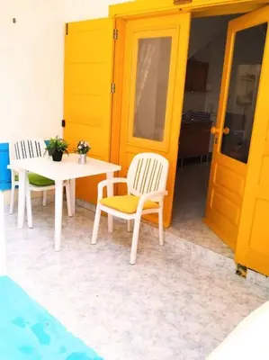 two chairs and a table and a table and a door at Feeling Cabo Verde in Beirona
