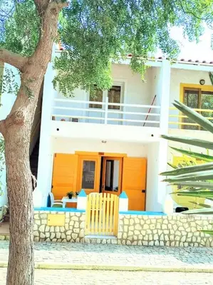 a white house with a tree in front of it at Feeling Cabo Verde in Beirona