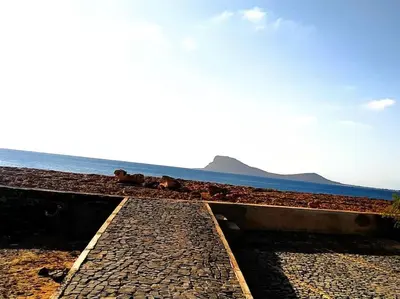 a stone path next to the ocean with the sky at Feeling Cabo Verde in Beirona