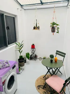 a living room with a washing machine and a table at SuAparts in Praia