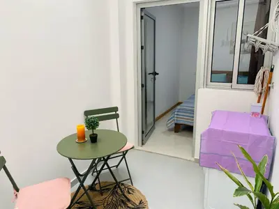 a small table and a chair in a room at SuAparts in Praia