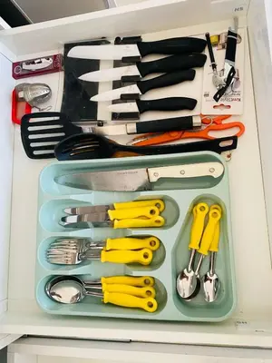 a drawer filled with lots of kitchen utensils at SuAparts in Praia