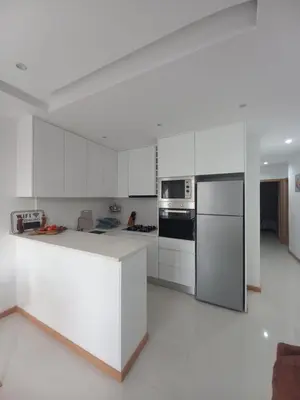 a white kitchen with a refrigerator and a stove at SuAparts in Praia
