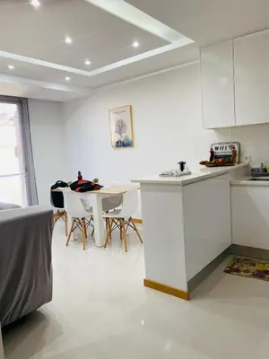 a kitchen and dining room with a table and chairs at SuAparts in Praia