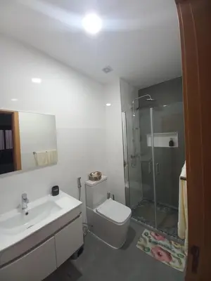 a bathroom with a shower and a toilet and a sink at SuAparts in Praia
