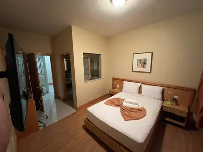 a bedroom with a bed with a robe on it at Spencer Residencial QUARTOS in Praia