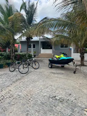 a group of bikes and a boat parked in front of a house at Residência Águia in Praia
