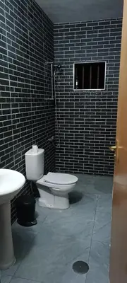 a bathroom with a white toilet and a shower at Residência Águia in Praia