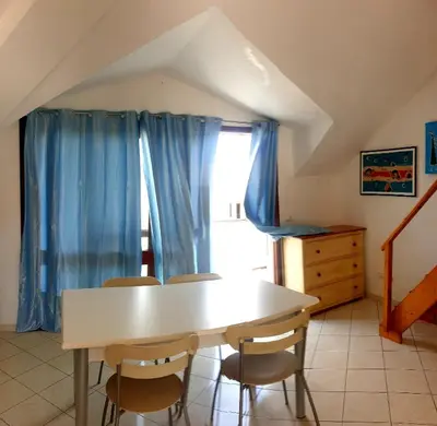 a dining room with a white table and chairs at Residencial Ilha do Fogo app 205 in Santa Maria