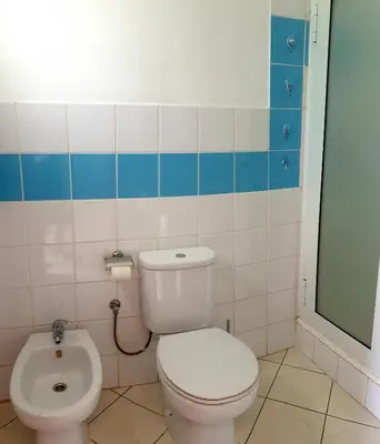 a bathroom with a white toilet and a bidet at Residencial Ilha do Fogo app 205 in Santa Maria