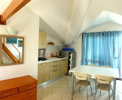 a kitchen with a white table and chairs at Residencial Ilha do Fogo app 205 in Santa Maria