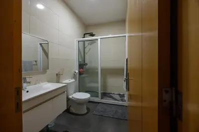 a bathroom with a shower and a toilet and a sink at Villa RESIDENCIAL EUNICE in Praia
