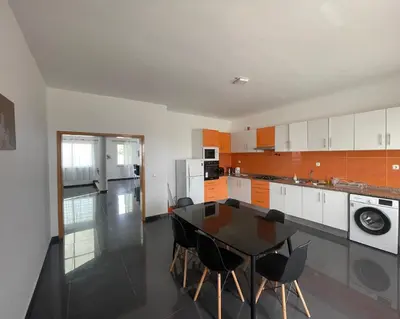 a kitchen with a table and chairs in it at Villa RESIDENCIAL EUNICE in Praia