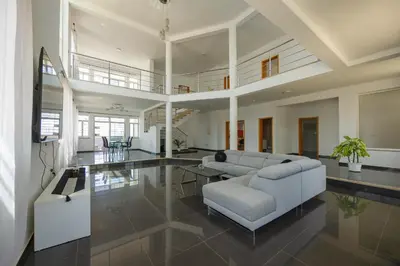 a living room with a couch and a table at Villa RESIDENCIAL EUNICE in Praia