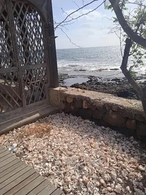 an open door to a beach with the ocean at L2B - São Vicente in Mindelo