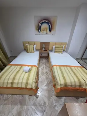 two beds sitting next to each other in a room at Djeu View in Praia