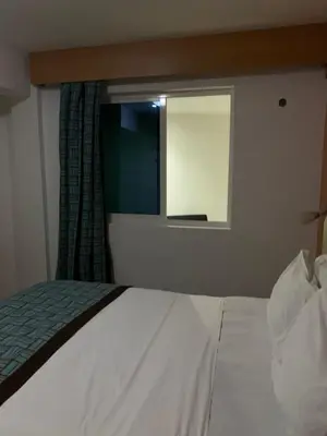 a bedroom with a white bed and a window at Djeu View in Praia