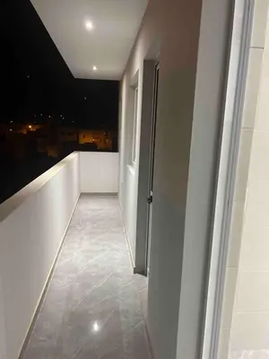 a room with a balcony with a view of a city at Brand new apartment in Mindelo in Mindelo