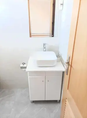 a bathroom with a white sink and a mirror at Brand new apartment in Mindelo in Mindelo