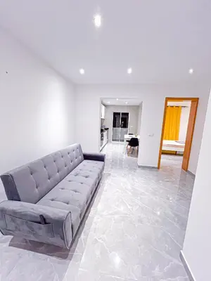 a living room with a couch and a table at Brand new apartment in Mindelo in Mindelo