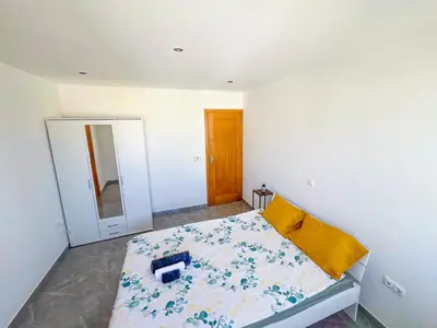 a bedroom with a bed and a mirror in it at Brand new apartment in Mindelo in Mindelo