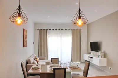 a living room with a table and a dining room at KANDAKE APARTMENT Sal Rei Wi-Fi in Sal Rei