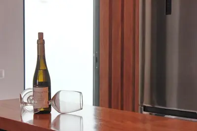 a bottle of wine sitting on top of a table at KANDAKE APARTMENT Sal Rei Wi-Fi in Sal Rei